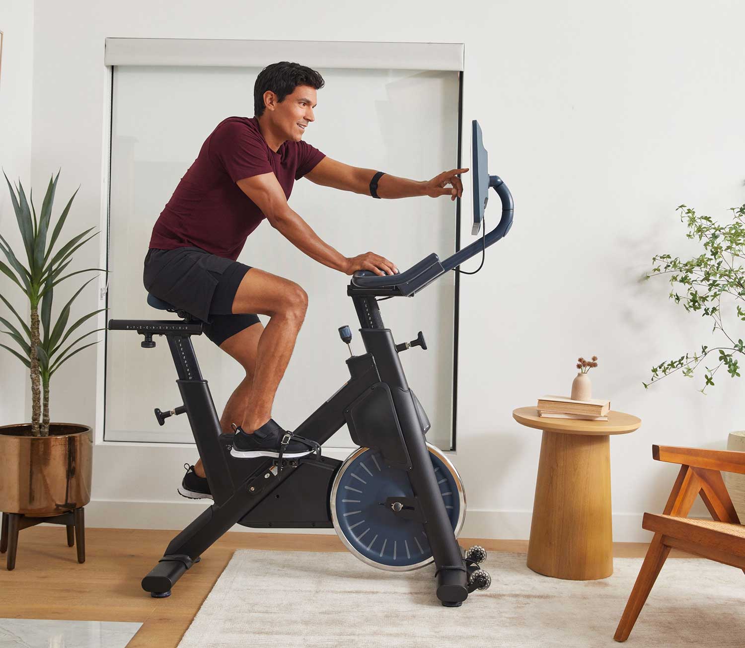 BODi+MYXFitness customer selecting his workout on his new MYX excercise bike