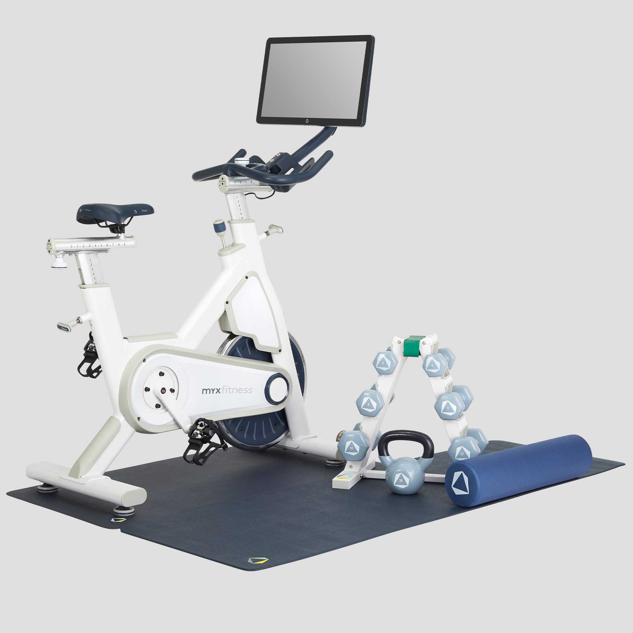 The BODi Bike+ Home Studio in Natural White with weight rack, foam roller, spri stretch band, kettlebell and floor mats
